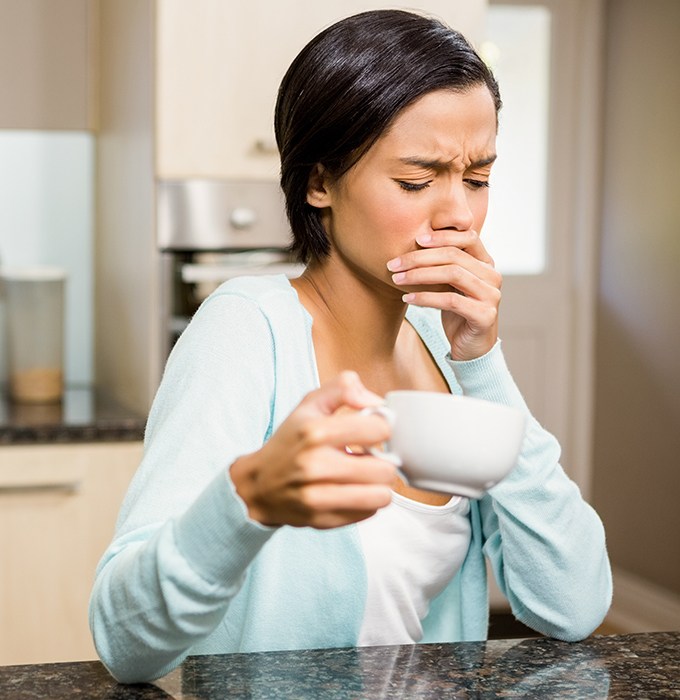 Woman with tooth sensitivity in need of emergency dentistry