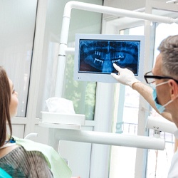 dental implant dentist in Flint showing patient their X-rays