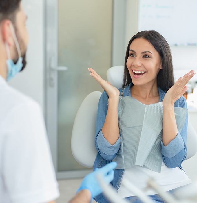 Woman smiling at dentist after one visit dental restoration