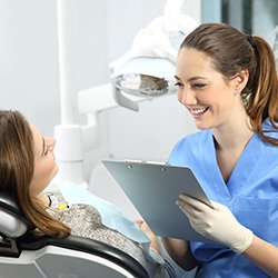 woman smiling while talking about cost of cosmetic dentistry in Flint   