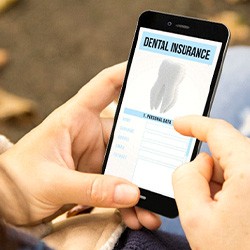 Close-up of woman checking dental insurance form on phone