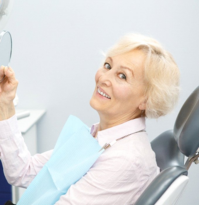 Senior patient in dental chair with dentures in Flint