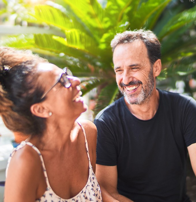 Older couple smiling and laughing outside