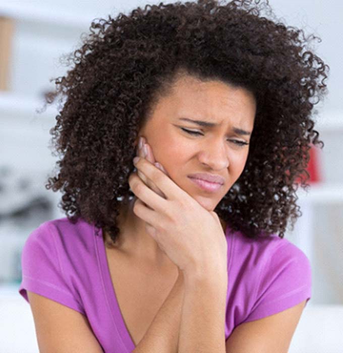 Woman with dental implants in Flint, MI looking concerned