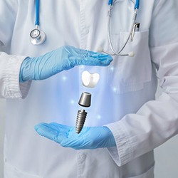 implant dentist in Flint showing a tablet to a patient 