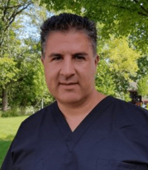 Flint dentist Doctor Steven Rodriguez smiling outdoors