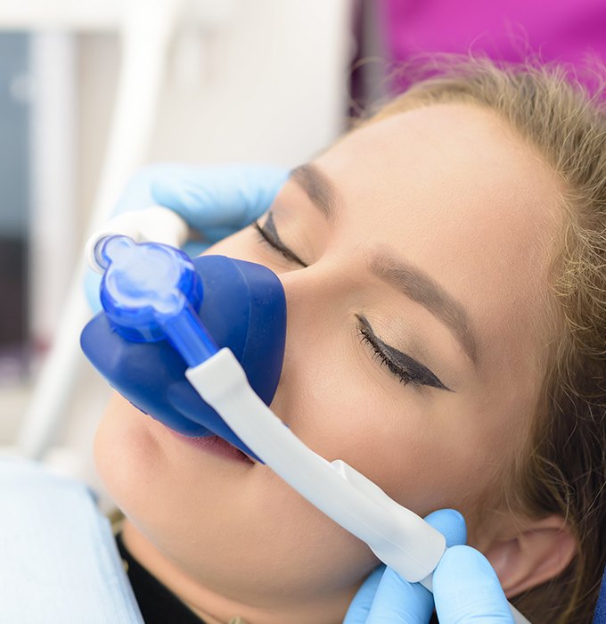 Woman with nitrous oxide dental sedation mask in place