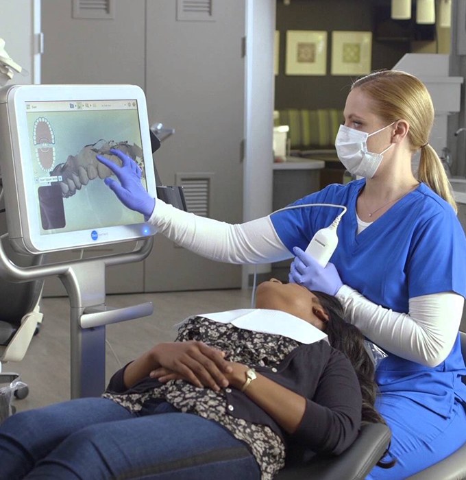 Dental team member using intraoral camera to capture smile images