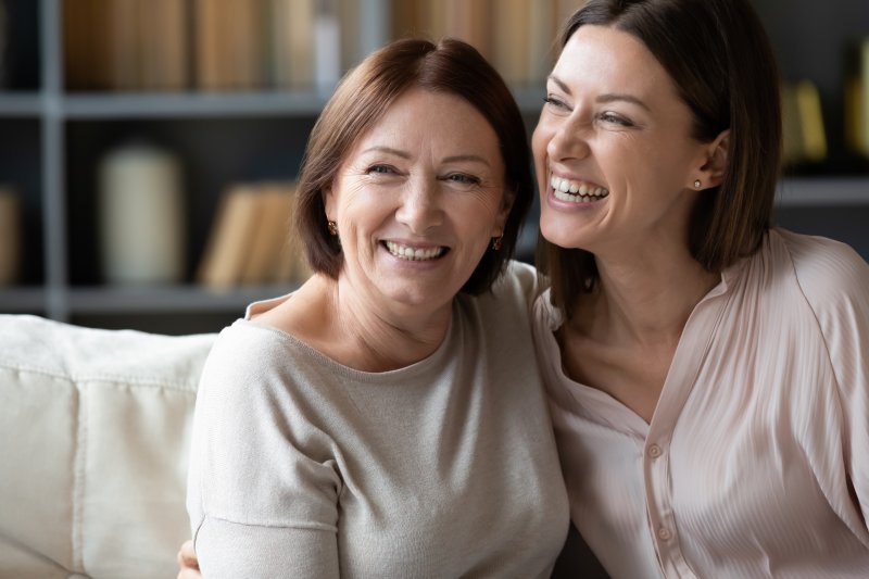 mother and adult daughter laughing together