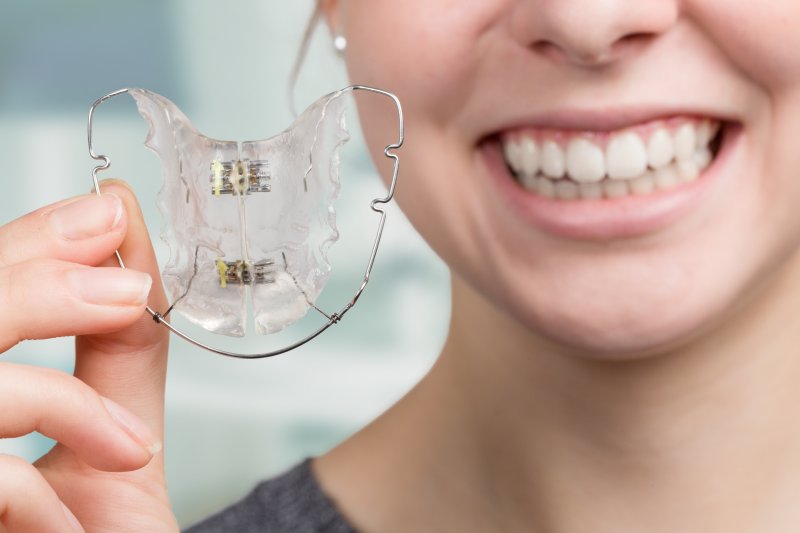 girl holding retainer