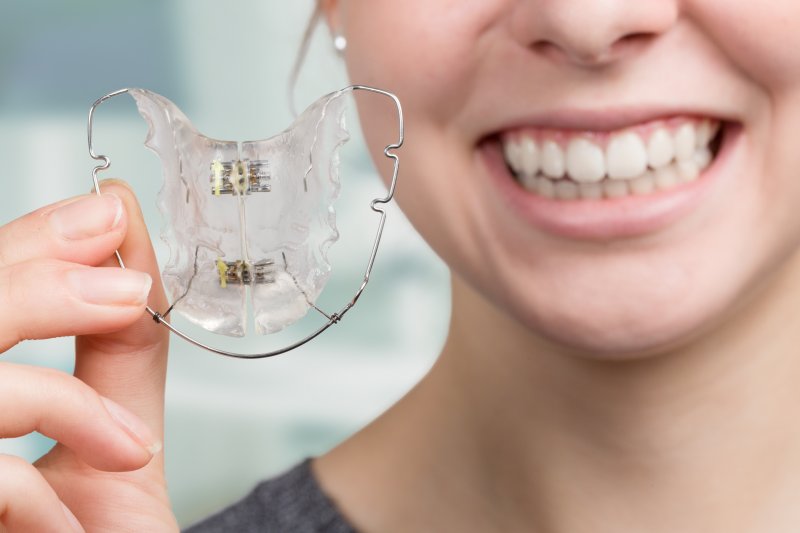 girl holding retainer 