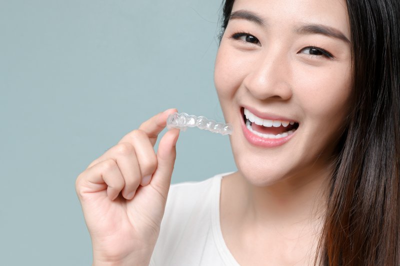 person holding clear aligner trays
